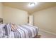 Cozy bedroom with a striped comforter and neutral decor offers a calm, inviting space at 8316 Accolade St, Las Vegas, NV 89139