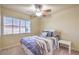 Bedroom with a ceiling fan and window, offering plenty of natural light at 8316 Accolade St, Las Vegas, NV 89139