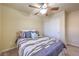 Comfortable bedroom with ceiling fan and closet, featuring a colorful striped comforter at 8316 Accolade St, Las Vegas, NV 89139