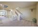 Bright hallway features plush carpeting, stairs to lower level, and access to various rooms within the home at 8316 Accolade St, Las Vegas, NV 89139