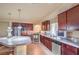 Modern kitchen with stainless steel appliances, granite countertops, and dark wooden cabinets at 8316 Accolade St, Las Vegas, NV 89139
