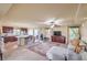Open-concept living room features a comfortable sofa, ceiling fan, and lots of natural light at 8316 Accolade St, Las Vegas, NV 89139