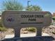 View of the Cougar Creek Park sign with a clear blue sky in the background at 8316 Accolade St, Las Vegas, NV 89139