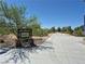 Concrete path leads to an open area with lush greenery and trees at 8316 Accolade St, Las Vegas, NV 89139