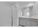 Modern bathroom with a glass-enclosed shower and vanity with gray cabinetry at 8436 Noir Ave, Las Vegas, NV 89129