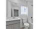 Bathroom featuring a large mirror, neutral cabinets, and a shower-tub combo at 8436 Noir Ave, Las Vegas, NV 89129