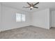 Carpeted bedroom with a large window providing natural light at 8436 Noir Ave, Las Vegas, NV 89129