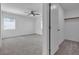 Bright, carpeted bedroom with ceiling fan, closet and natural light at 8436 Noir Ave, Las Vegas, NV 89129
