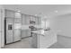 Modern kitchen with stainless steel appliances, center island, and sleek gray cabinetry at 8436 Noir Ave, Las Vegas, NV 89129
