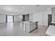 Open-concept kitchen and living area featuring a center island with sink and modern stainless appliances at 8436 Noir Ave, Las Vegas, NV 89129