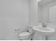 Modern half bathroom featuring a pedestal sink and toilet at 8436 Noir Ave, Las Vegas, NV 89129
