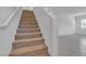 A well-maintained carpeted staircase with white walls and tile floors at 8436 Noir Ave, Las Vegas, NV 89129