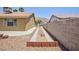 Backyard featuring desert landscaping and concrete walkway at 849 Ringwood Ln, Las Vegas, NV 89110