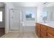 Bright bathroom with a tub, shower, and wood-finished vanity at 849 Ringwood Ln, Las Vegas, NV 89110