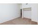 Clean bedroom with neutral carpet, ceiling fan, closet, and a door into another room at 849 Ringwood Ln, Las Vegas, NV 89110