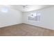 Spacious bedroom featuring neutral carpet, ceiling fan, and ample natural light at 849 Ringwood Ln, Las Vegas, NV 89110