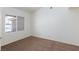 This bedroom boasts plush carpeting and a bright window with neighborhood views at 849 Ringwood Ln, Las Vegas, NV 89110