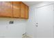 Functional laundry room with overhead cabinets, utility sink connections, and easy access to the outdoors at 849 Ringwood Ln, Las Vegas, NV 89110