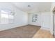 Well-lit living room featuring neutral carpet, large windows and laminate flooring at 849 Ringwood Ln, Las Vegas, NV 89110