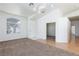 Bright living room with neutral carpet, a large window, and laminate flooring entrance at 849 Ringwood Ln, Las Vegas, NV 89110