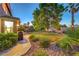 Private backyard featuring lush greenery, mature trees, and a serene setting at 8812 Glenistar Gate Ave, Las Vegas, NV 89143