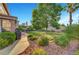 Serene backyard with lush landscaping, mature trees, and a well-maintained lawn at 8812 Glenistar Gate Ave, Las Vegas, NV 89143