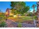 Private backyard retreat with mature trees, lush landscaping, and a tranquil atmosphere at 8812 Glenistar Gate Ave, Las Vegas, NV 89143
