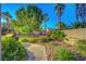 Secluded backyard oasis with mature palms, lush landscaping, and a peaceful ambiance at 8812 Glenistar Gate Ave, Las Vegas, NV 89143