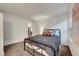 Cozy bedroom with soft carpet, black metal bed frame, and ensuite bathroom at 8812 Glenistar Gate Ave, Las Vegas, NV 89143