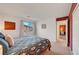 Well-lit bedroom with neutral carpet, bright walls, and a large window with backyard views at 8812 Glenistar Gate Ave, Las Vegas, NV 89143