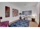 Bright bonus room with tan carpet, white walls, blue rug, and modern art at 8812 Glenistar Gate Ave, Las Vegas, NV 89143