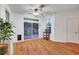 Sunny dining room with wood floors, a ceiling fan and access to the backyard at 8812 Glenistar Gate Ave, Las Vegas, NV 89143