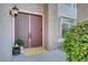 Inviting front entryway featuring double doors, stylish light fixture, and decorative potted plant at 8812 Glenistar Gate Ave, Las Vegas, NV 89143