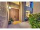 Inviting front entryway featuring a stylish double door, decorative lantern, and accent rug at 8812 Glenistar Gate Ave, Las Vegas, NV 89143
