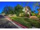 Well-maintained front lawn with mature trees and landscaping, adding curb appeal to the property at 8812 Glenistar Gate Ave, Las Vegas, NV 89143