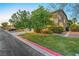 Charming two-story home with mature landscaping, green lawn and driveway at 8812 Glenistar Gate Ave, Las Vegas, NV 89143