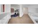 Bright hallway features neutral carpet, white walls, arches and decorative wall art at 8812 Glenistar Gate Ave, Las Vegas, NV 89143