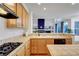 Kitchen features light wood cabinetry, tile countertops and an attached Gathering room at 8812 Glenistar Gate Ave, Las Vegas, NV 89143