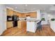Cozy kitchen featuring wood cabinets, black appliances, breakfast bar, and plenty of natural light at 8812 Glenistar Gate Ave, Las Vegas, NV 89143
