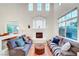 Bright living room with high ceilings, elegant fireplace, and large windows at 8812 Glenistar Gate Ave, Las Vegas, NV 89143
