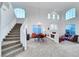 Bright, open living room features high ceilings, large windows, and a staircase at 8812 Glenistar Gate Ave, Las Vegas, NV 89143