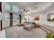 Bright living room with high ceilings, large windows, and open access to the kitchen at 8812 Glenistar Gate Ave, Las Vegas, NV 89143