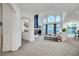 Open-concept living room boasts high ceilings, fireplace, and large windows with natural light at 8812 Glenistar Gate Ave, Las Vegas, NV 89143