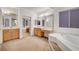 Bathroom features dual sinks, a soaking tub and a large vanity area at 8812 Glenistar Gate Ave, Las Vegas, NV 89143