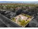 An aerial view with property lines shows a swimming pool in the backyard among mature landscaping at 9 Quail Run Rd, Henderson, NV 89014