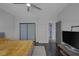 This bedroom features a ceiling fan, dark floors, closet, and a view to the hall at 9 Quail Run Rd, Henderson, NV 89014