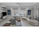 Open living room with ample seating, large windows, and a ceiling fan at 9 Quail Run Rd, Henderson, NV 89014
