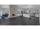 Open living space featuring a kitchen with stainless steel appliances and brick fireplace at 9 Quail Run Rd, Henderson, NV 89014