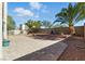 Spacious backyard featuring brick pavers, gravel, and mature landscaping for privacy and relaxation at 9004 Harbor Wind Ave, Las Vegas, NV 89178