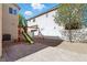 Gathering-friendly backyard with a play set, a gravel area, and a brick patio for outdoor enjoyment at 9004 Harbor Wind Ave, Las Vegas, NV 89178